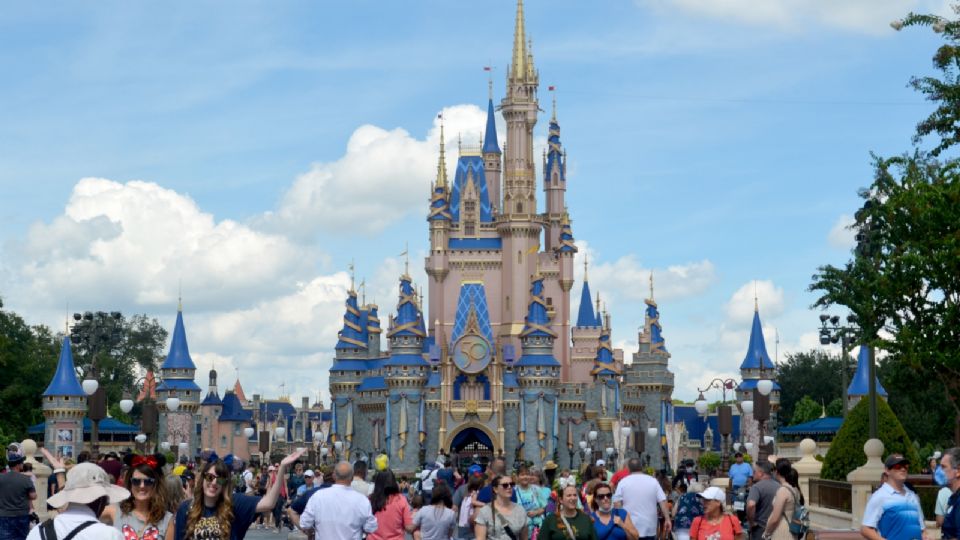 Fotografía de archivo del 30 de septiembre de 2021 donde aparecen unas personas mientras caminan frente al redecorado palacio de la Cenicienta con ocasión del 50 aniversario de Walt Disney World