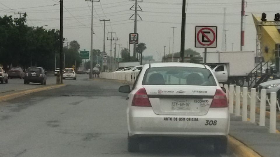 Auto del municipio de Escobedo estacionado en un lugar prohibido a las afueras de la Plaza Outlet.