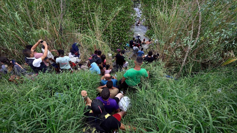 Personas migrantes intentando cruzar el Río Bravo.