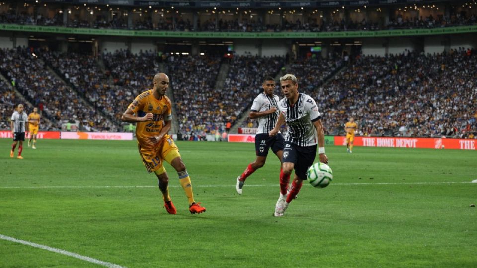 Guido Pizarro y Héctor Moreno pelean por un balón en el área en el Clásico Regio