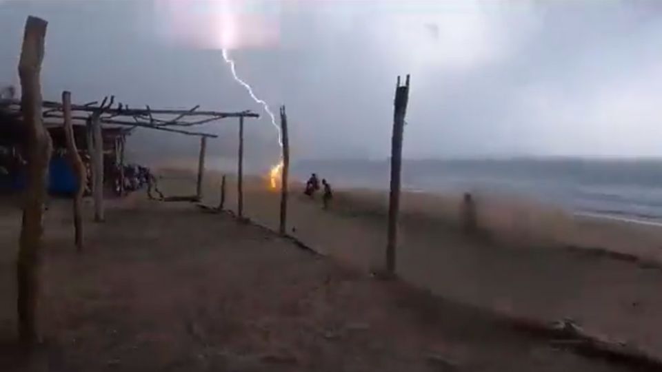 Momento en cae rayo en una playa de Aquila, Michoacán.