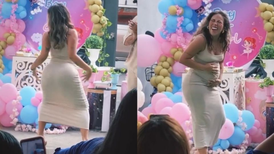 Mujer bailando en revelación de bebé.