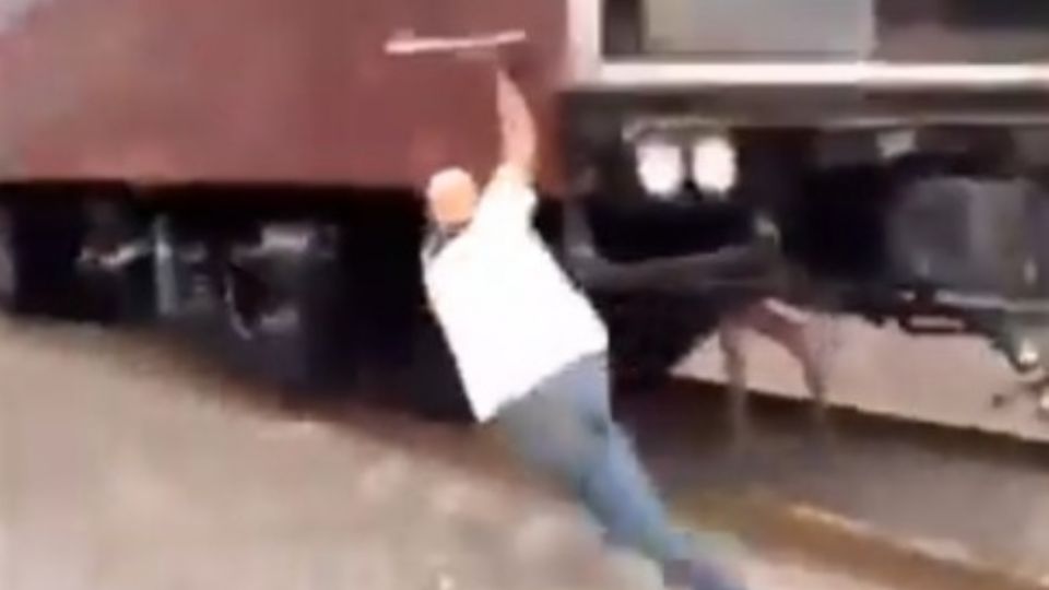 Hombre se cuelga de locomotora en movimiento