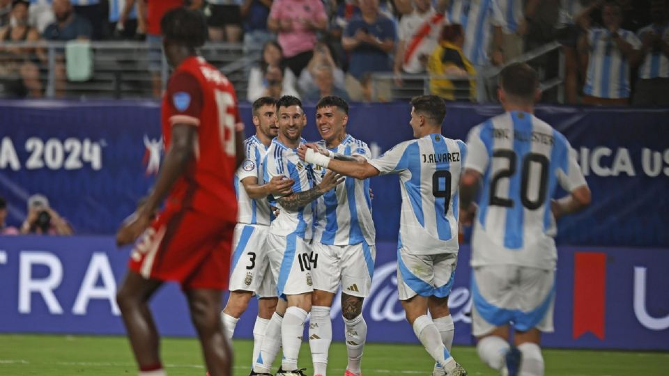 Lionel Messi de Argentina es recibido por sus compañeros después de marcar un gol contra Canadá.