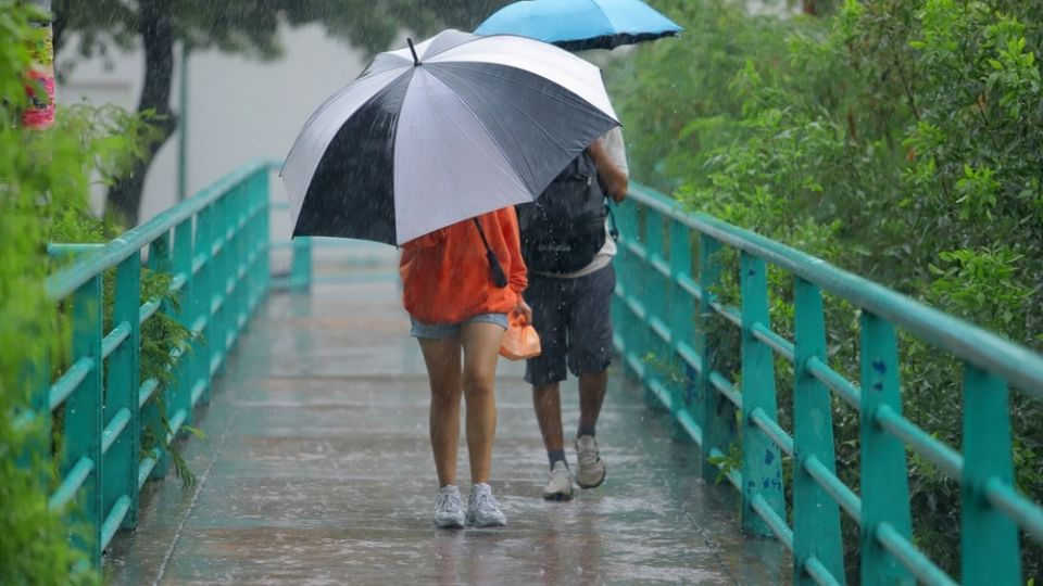 Personas cubriéndose de la lluvia en calles de Monterrey, NL