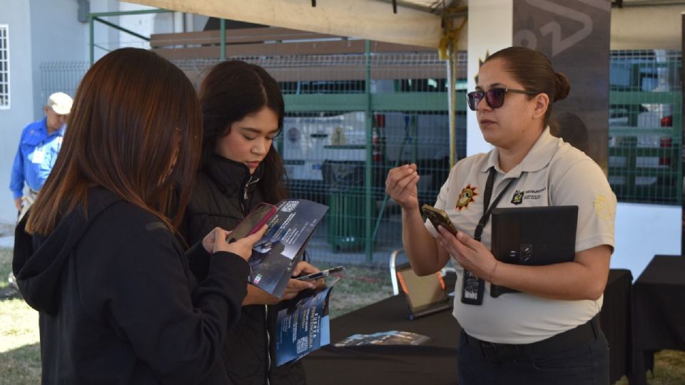 Alumnos reciben folletos y explicaciones durante la Semana de la Criminología